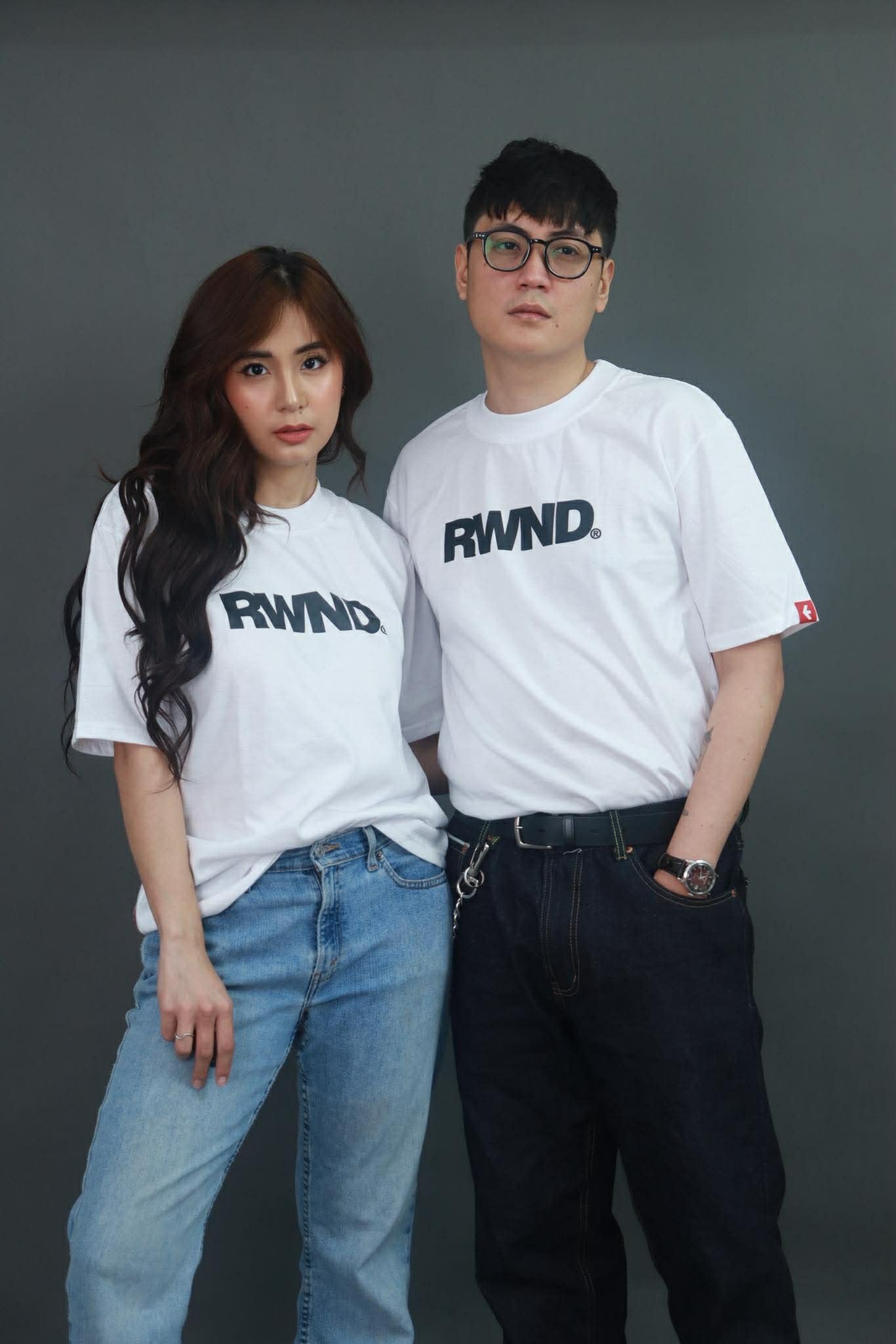 Male and Female model wearing the Rewind "R" Logo Tee in White, front view